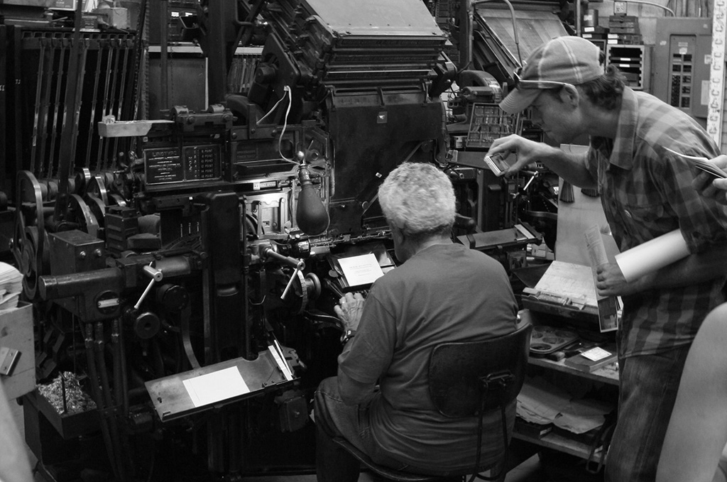 Man typing on Linotype press.